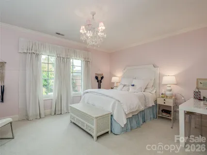 a bedroom with furniture and a chandelier