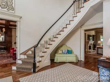 a view of entryway and hall with wooden floor