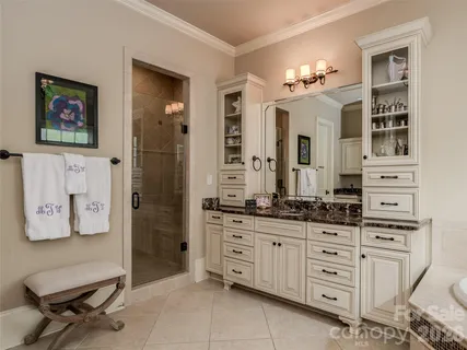a spacious en suite bathroom with a double vanity sink and a mirror