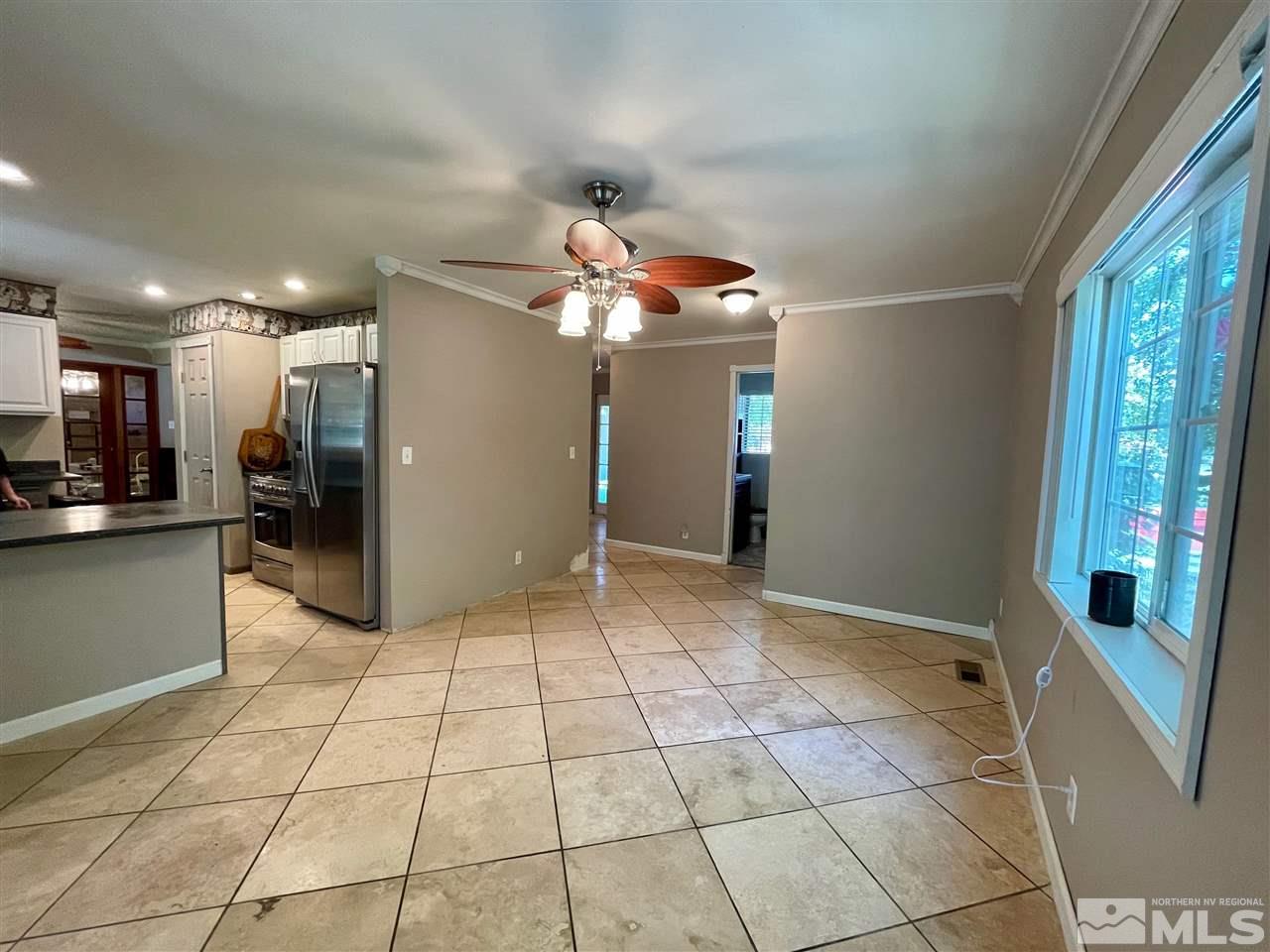814 McLean Road Fallon, NV 89406 - Photo 11 of 40 a view of a hallway with a chandelier