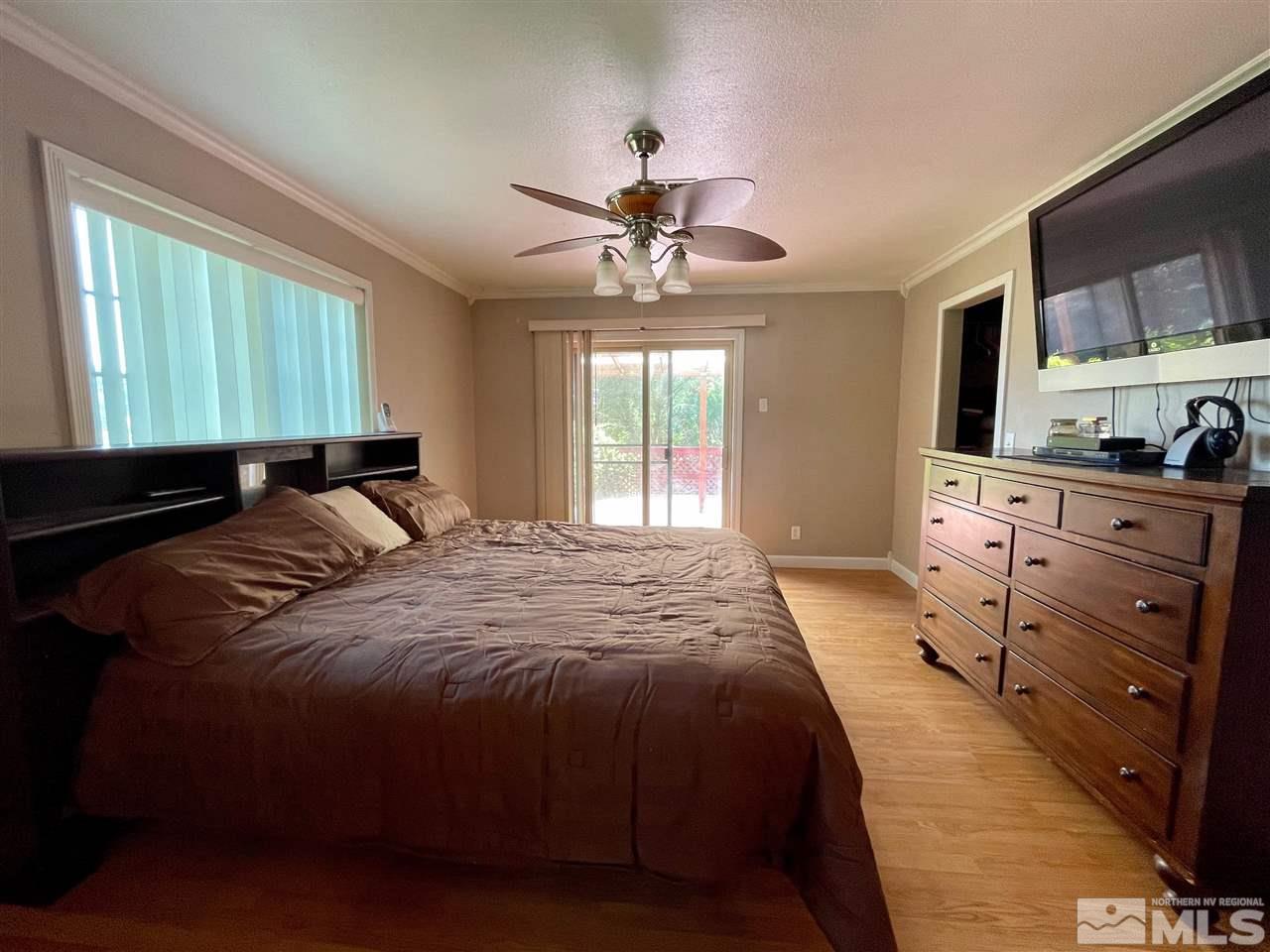 814 McLean Road Fallon, NV 89406 - Photo 20 of 40 a bedroom with a bed and a chandelier