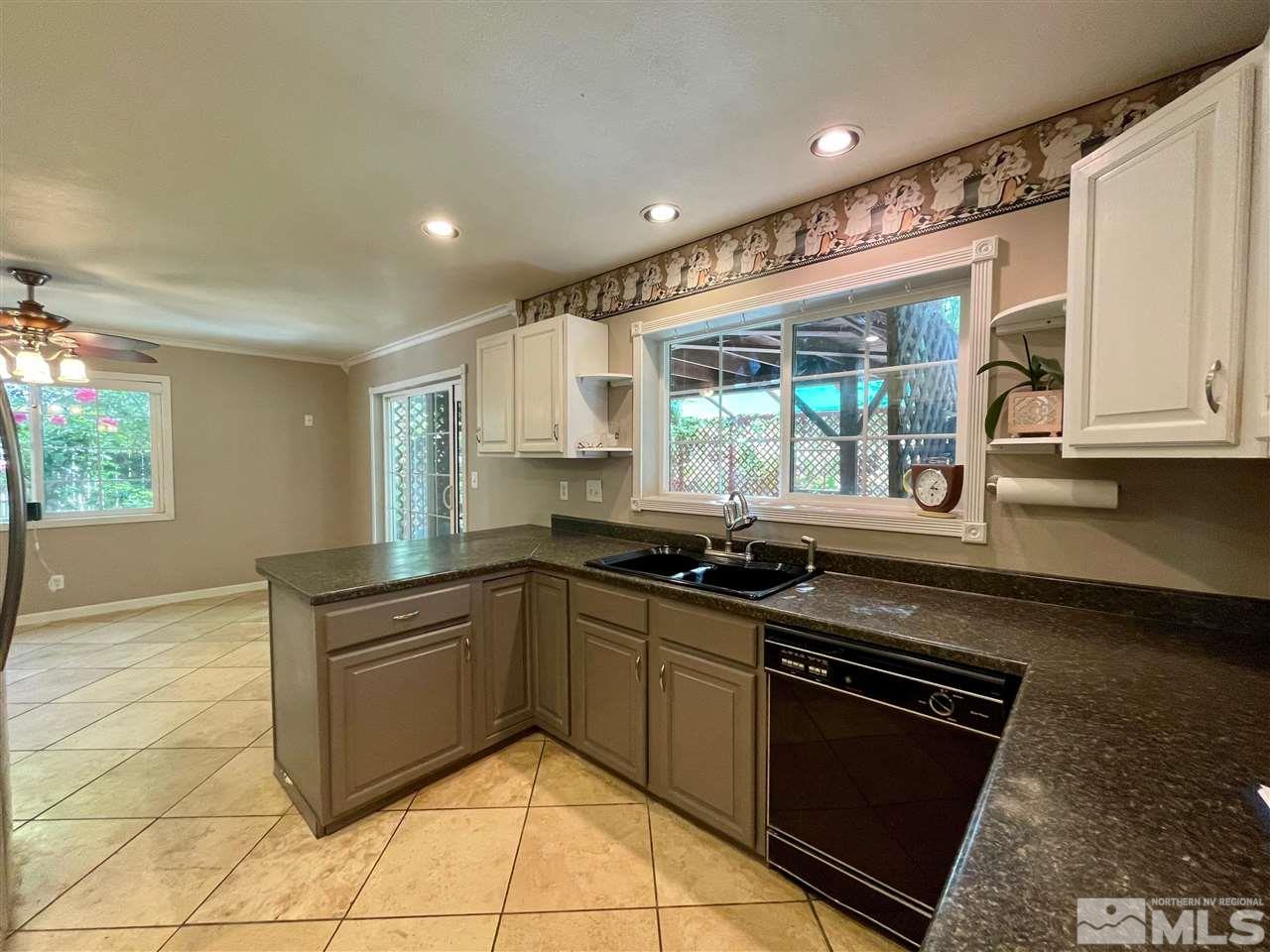 814 McLean Road Fallon, NV 89406 - Photo 9 of 40 a kitchen with stainless steel appliances granite countertop a stove sink and cabinets