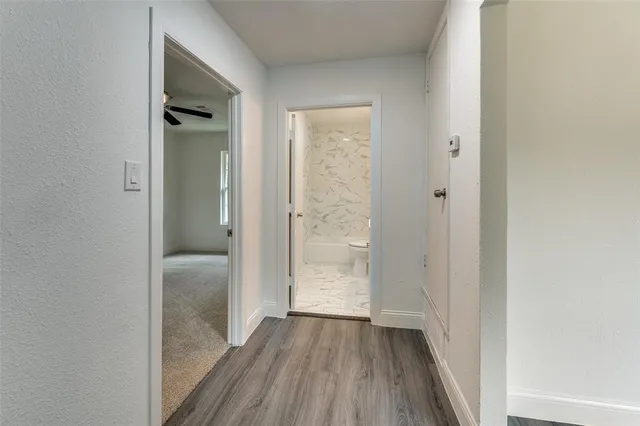 a view of a hallway with wooden floor