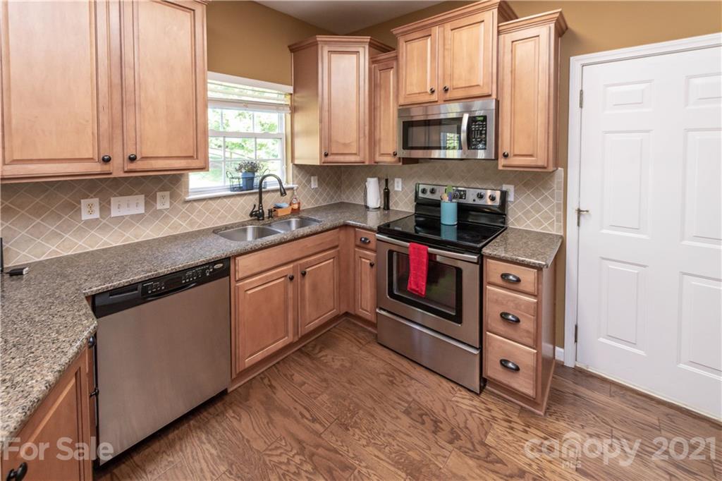 831 Knightsbridge Road, Unit 5 Fort Mill, SC 29708 - Photo 22 of 32 a kitchen with stainless steel appliances granite countertop a stove a sink and a microwave