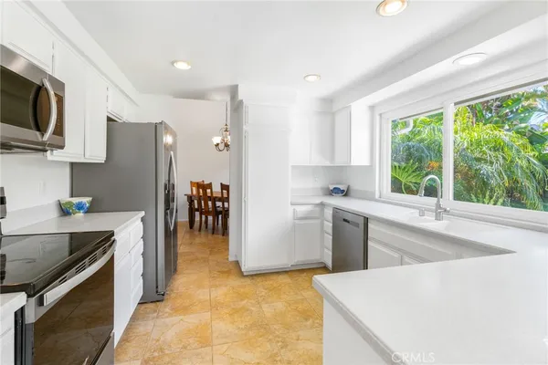 a kitchen with a refrigerator and a sink
