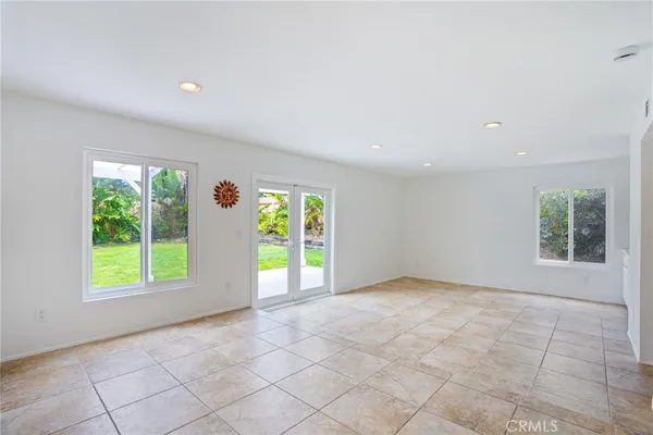 an empty room with windows and garden