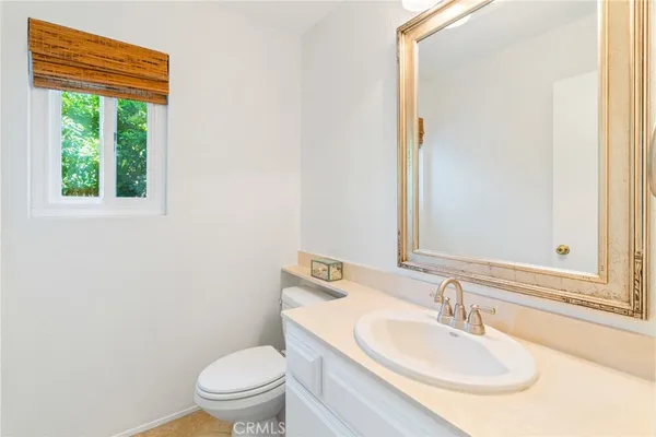 a bathroom with a sink toilet and a mirror