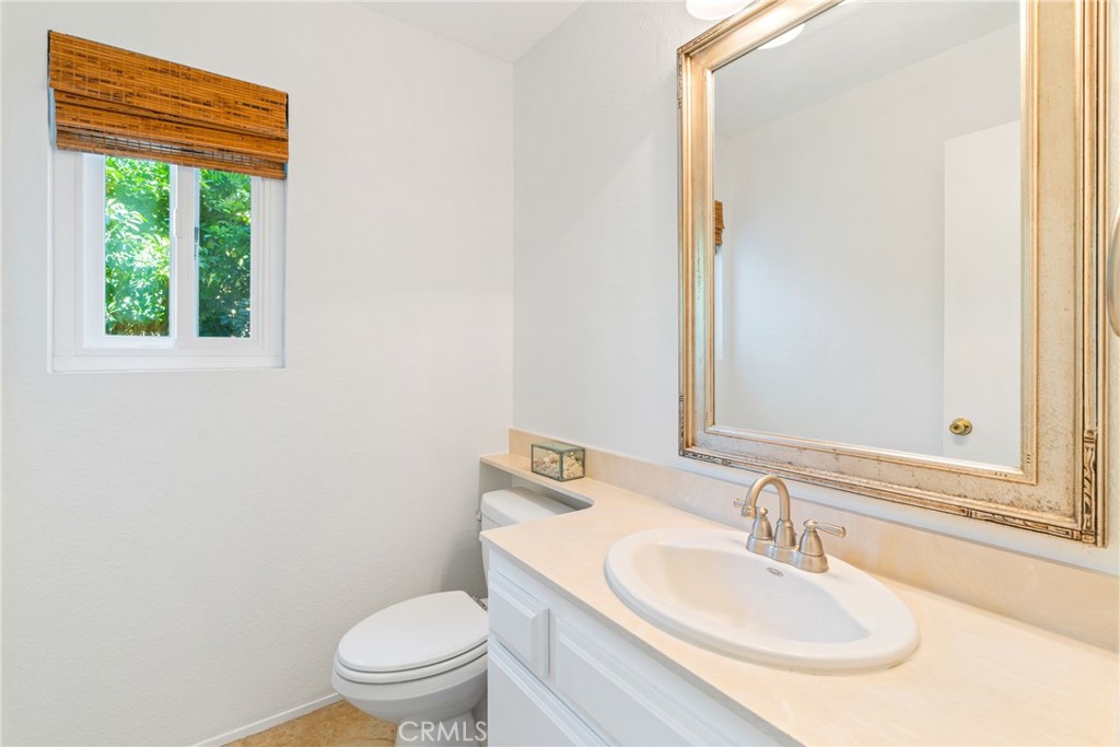 2204 Recodo Court Carlsbad, CA 92009 - Photo 21 of 44 a bathroom with a sink toilet and a mirror