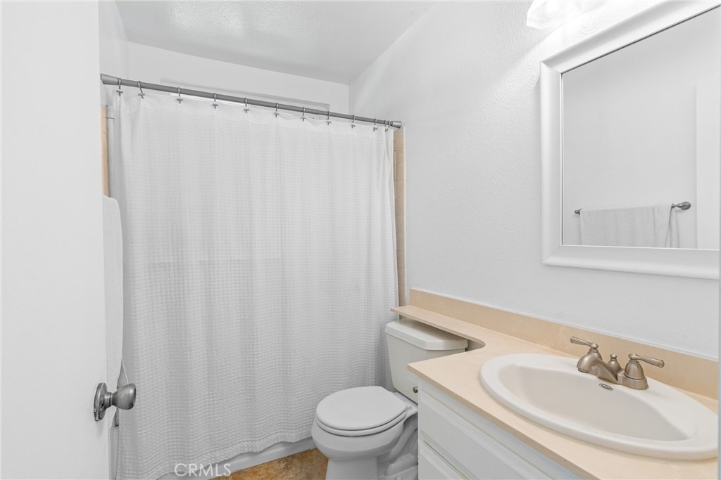 2204 Recodo Court Carlsbad, CA 92009 - Photo 33 of 44 a bathroom with a sink toilet and a mirror