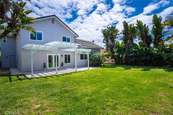 a view of a house with a yard and plants