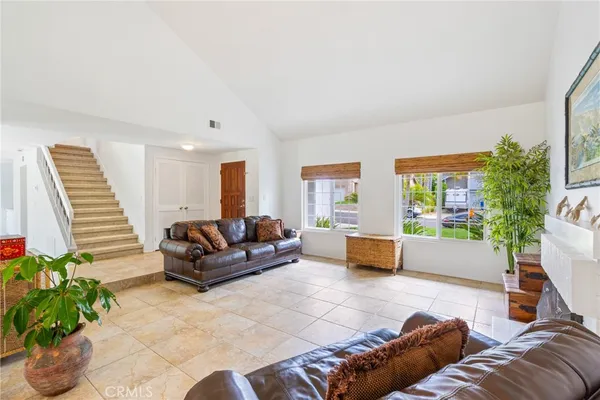 a living room with furniture and a potted plant