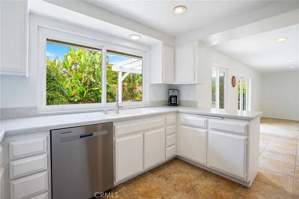 a kitchen with a sink cabinets and window