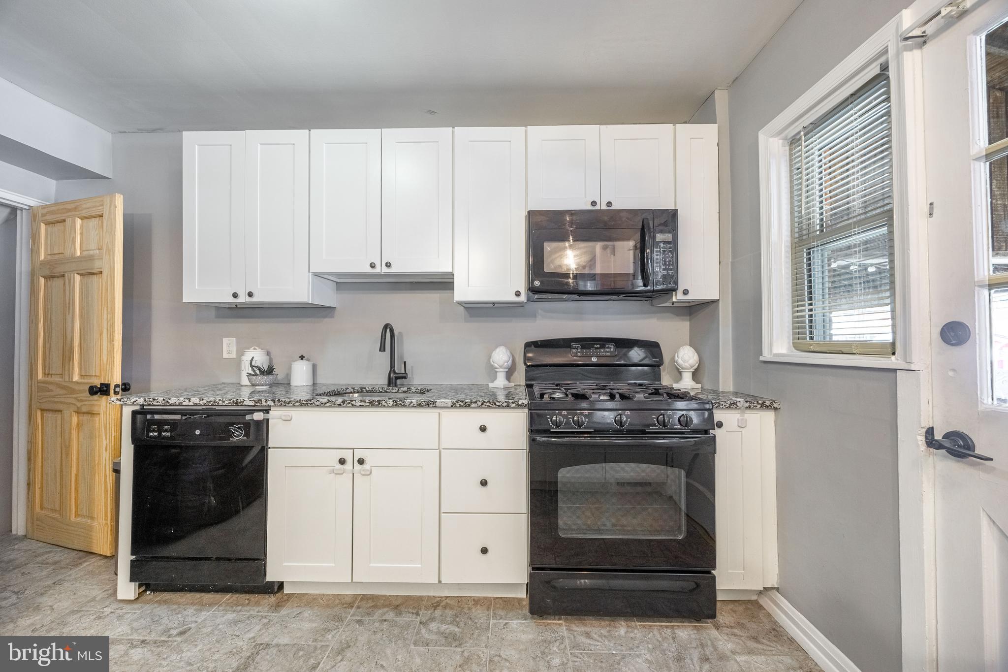 1953 Wareham Road Baltimore, MD 21222 - Photo 14 of 40 a kitchen with granite countertop a stove sink and cabinets