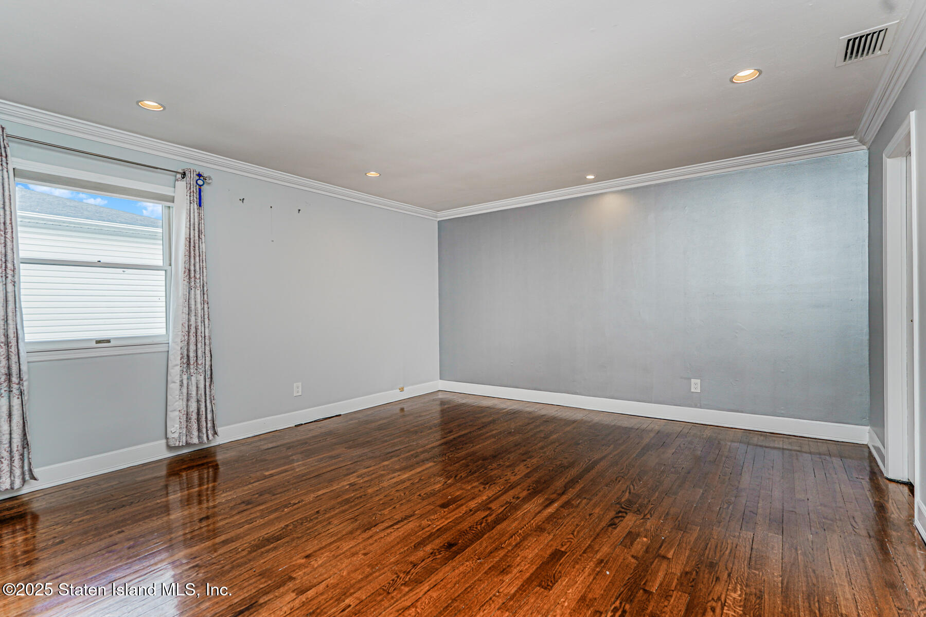 284 Todt Hill Road Staten Island, NY 10314 - Photo 16 of 29 a view of an empty room with wooden floor and closet