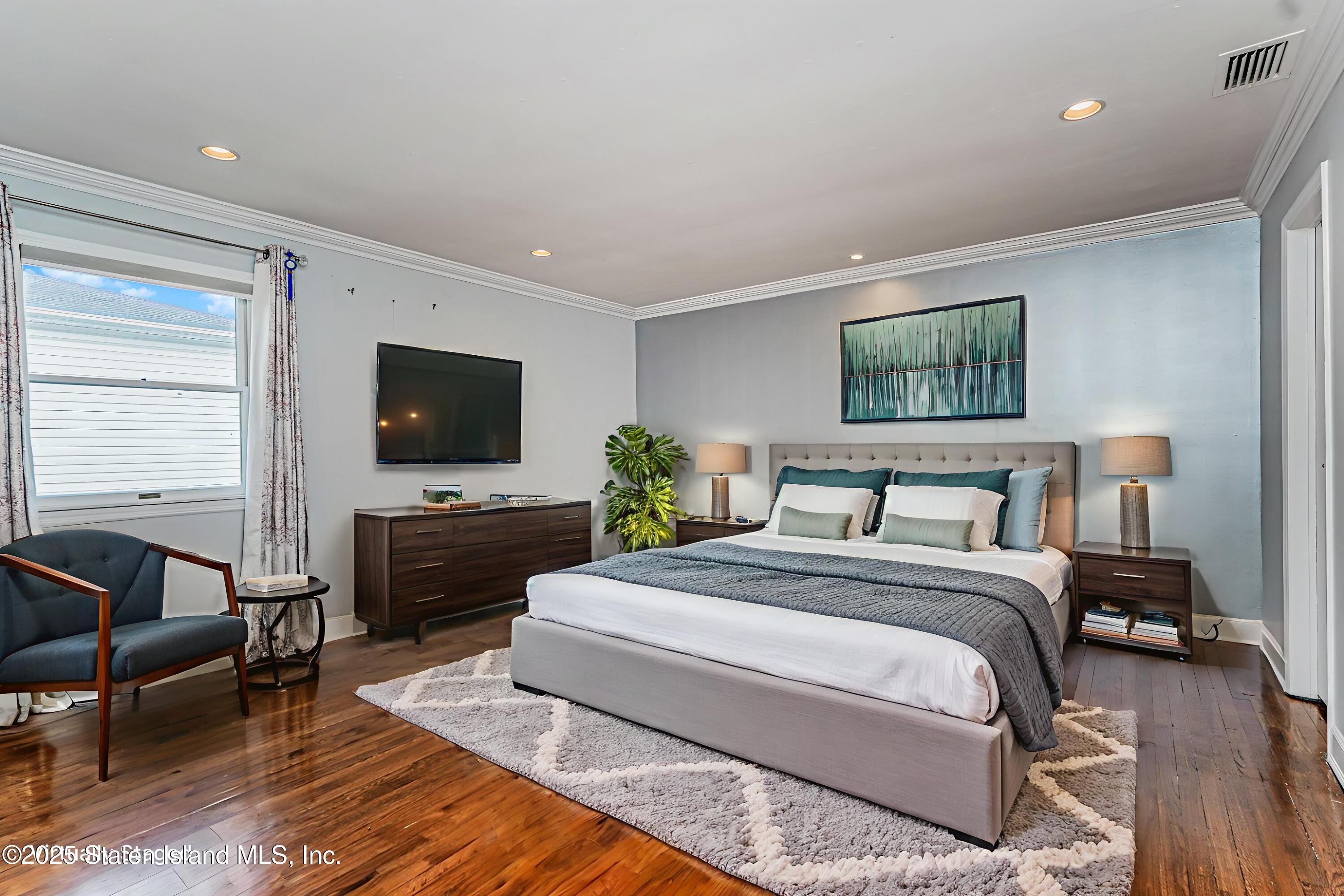 284 Todt Hill Road Staten Island, NY 10314 - Photo 17 of 29 a bedroom with a bed and a flat screen tv