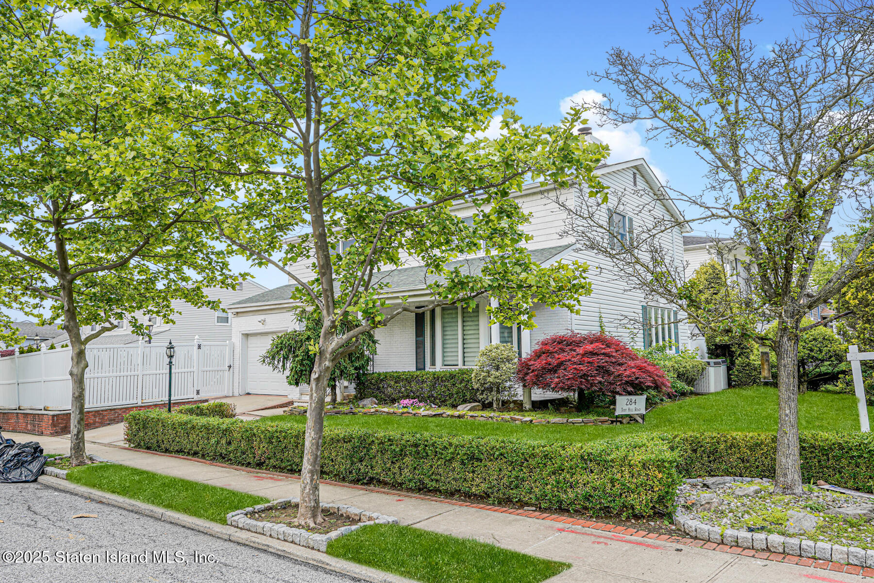 284 Todt Hill Road Staten Island, NY 10314 - Photo 2 of 29 a front view of a house with garden