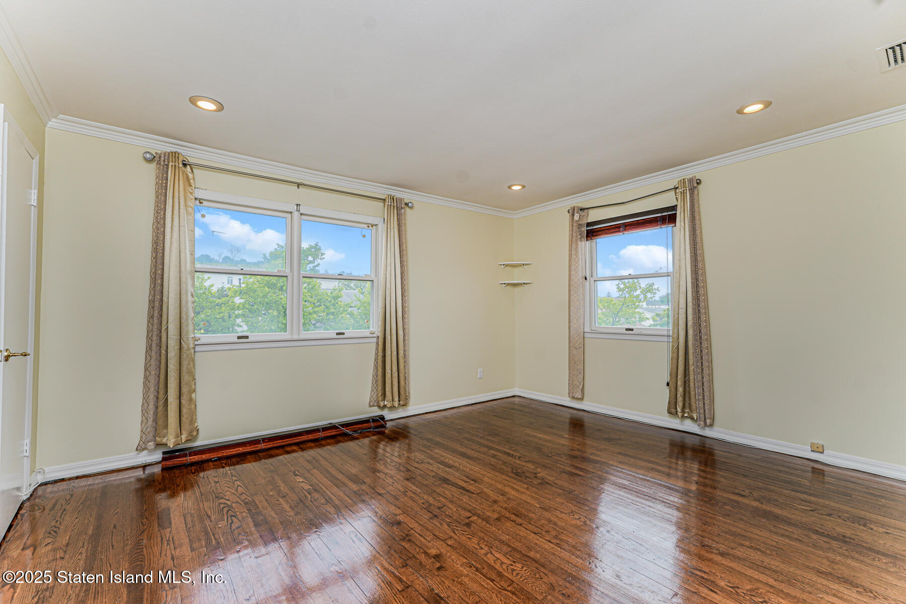 284 Todt Hill Road Staten Island, NY 10314 - Photo 21 of 29 an empty room with wooden floor and windows