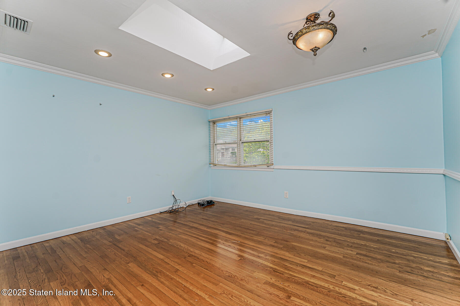 284 Todt Hill Road Staten Island, NY 10314 - Photo 23 of 29 an empty room with wooden floor and windows