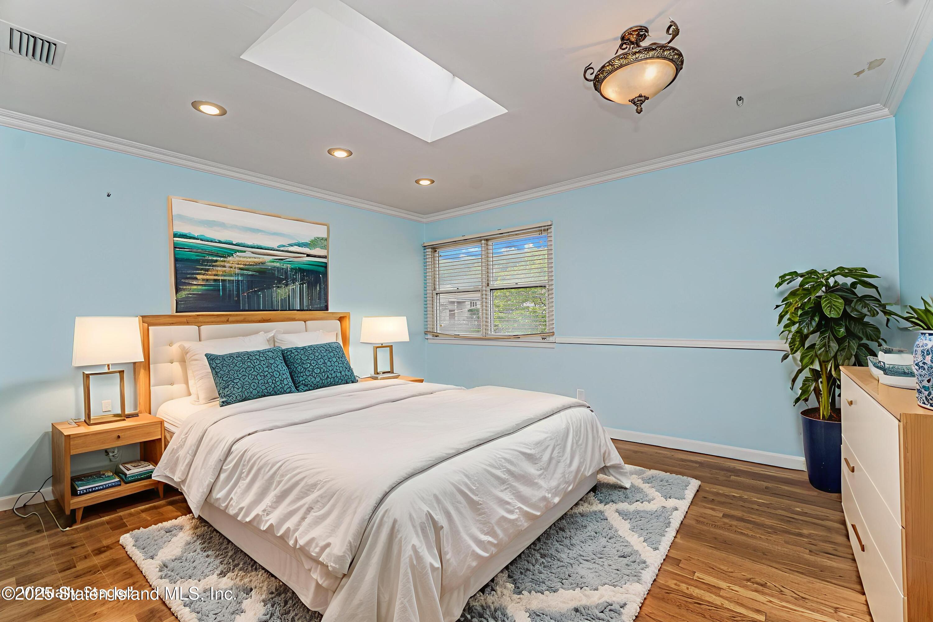 284 Todt Hill Road Staten Island, NY 10314 - Photo 24 of 29 a bedroom with a bed and a potted plant