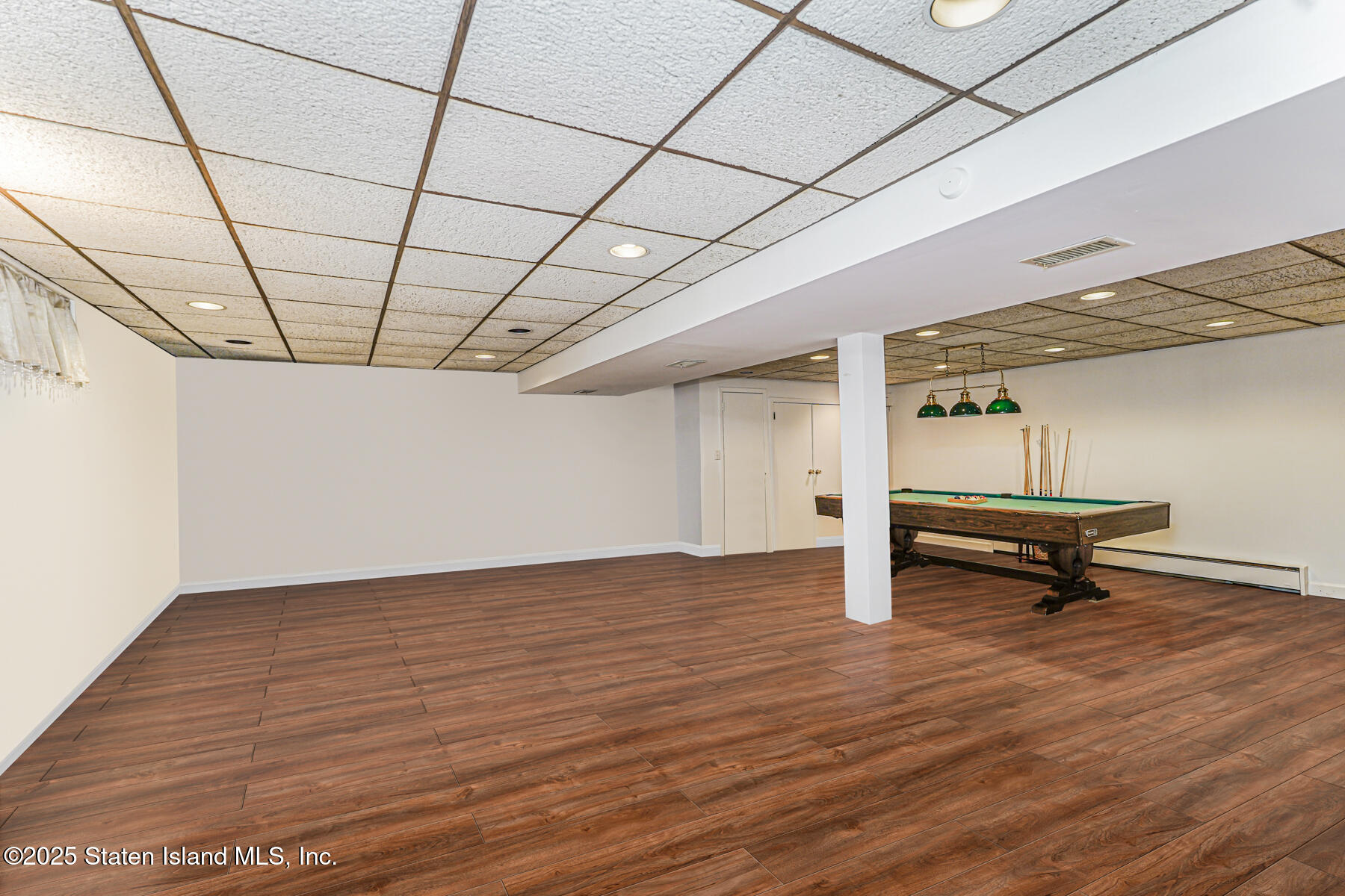 284 Todt Hill Road Staten Island, NY 10314 - Photo 25 of 29 a view of a room with wooden floor and a wooden bench