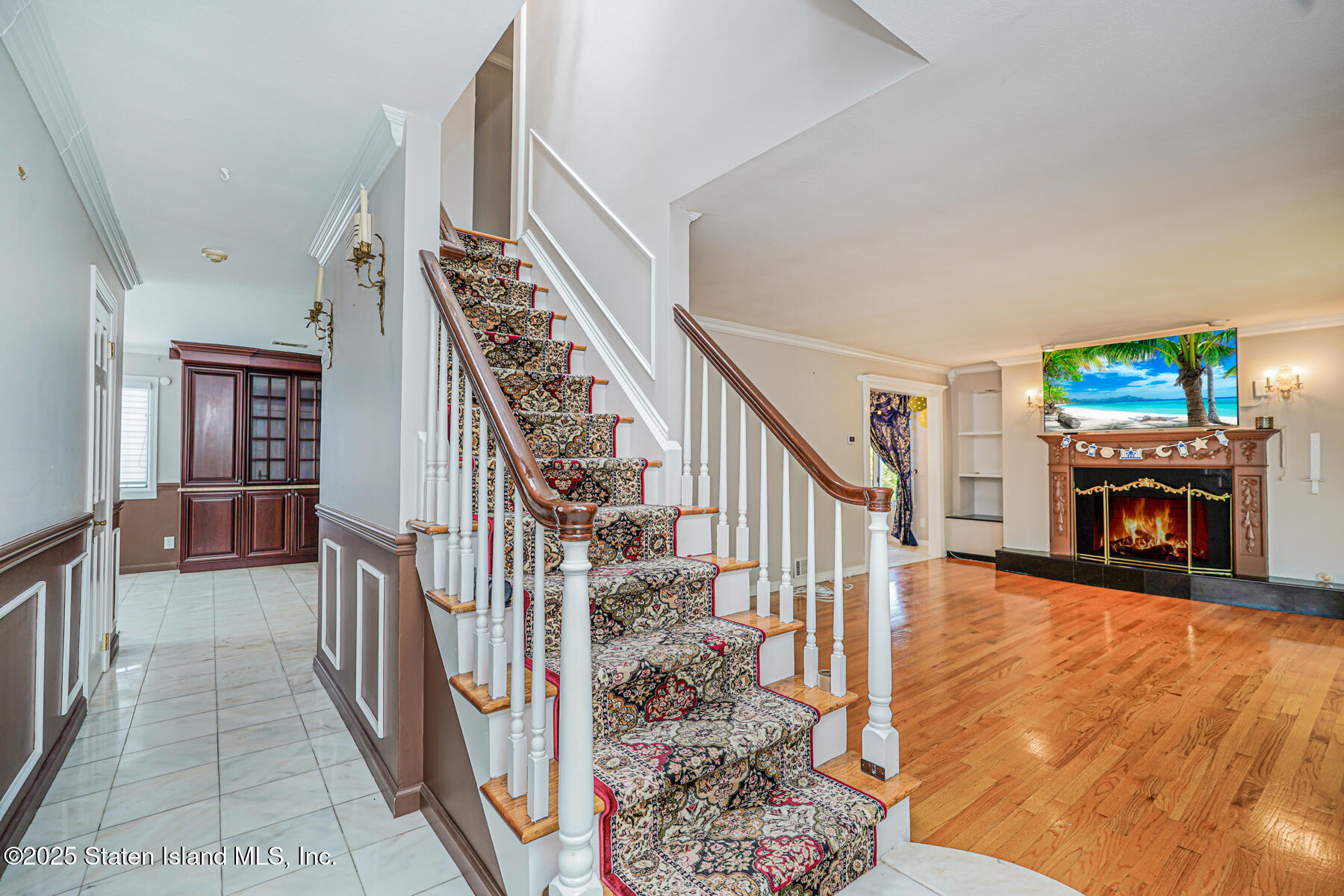 284 Todt Hill Road Staten Island, NY 10314 - Photo 4 of 29 a view of a livingroom with wooden floor and a fireplace