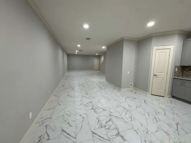 a view of a hallway to a kitchen