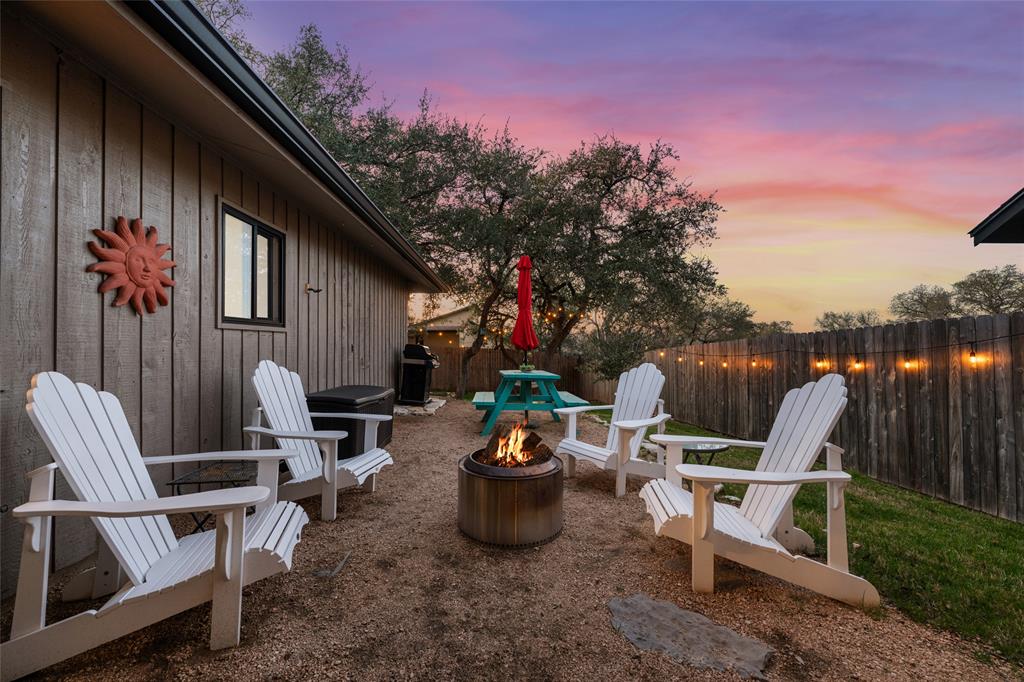 2210 Red Fox Road Austin, TX 78734 - Photo 5 of 40 Gather around the cozy fire pit on a gravel patio for intimate evenings under a vivid sunset.