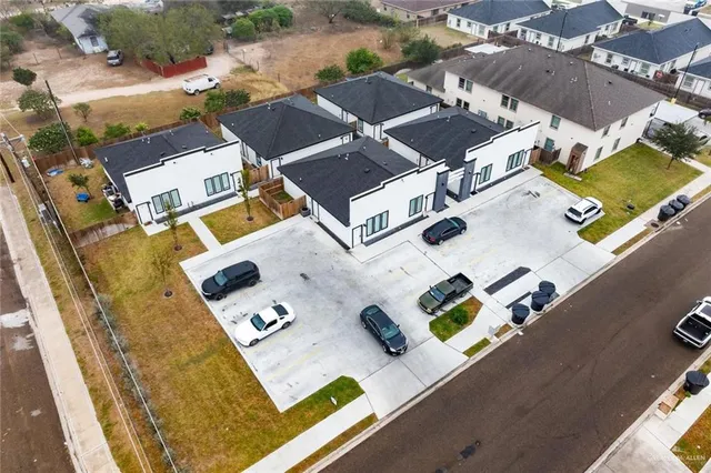 an aerial view of residential house with parking