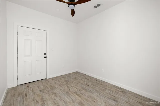 a view of a room with wooden floor