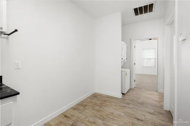 a view of a room with wooden floor and a sink