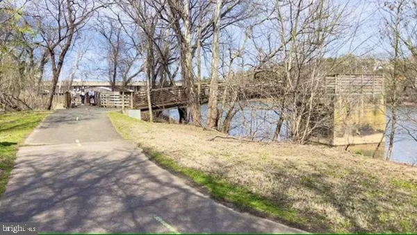 a living room with furniture wooden floor and a large window