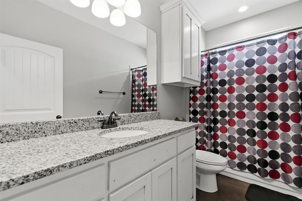 711 Hadley Lane Valley View, TX 76272 - Photo 24 of 40 Bathroom with vanity, a shower with shower curtain, and dark wood-style flooring