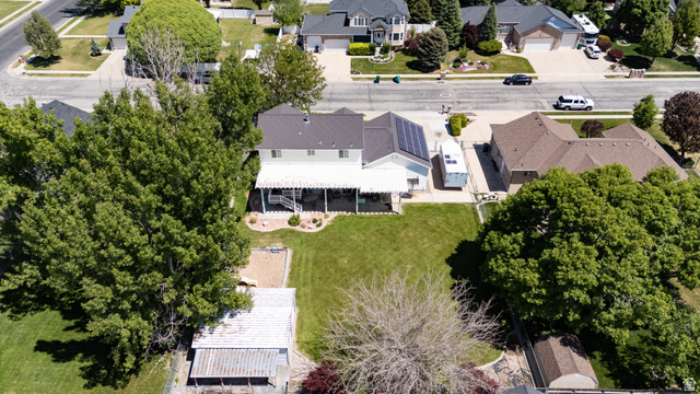 5727 South 3550th Street West Roy, UT 84067 - Photo 45 of 49 Expansive backyard featuring a manicured lawn, mature trees, and a detached outbuilding
