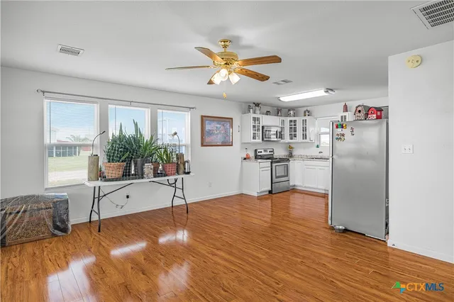 a bedroom with a bed and a potted plant on table