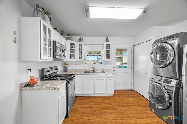 a kitchen with stainless steel appliances granite countertop a stove and a sink