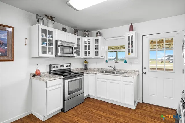a utility room with sink dryer and washer