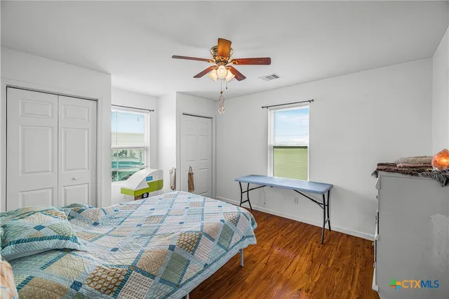 a bathroom with a granite countertop sink a toilet and shower