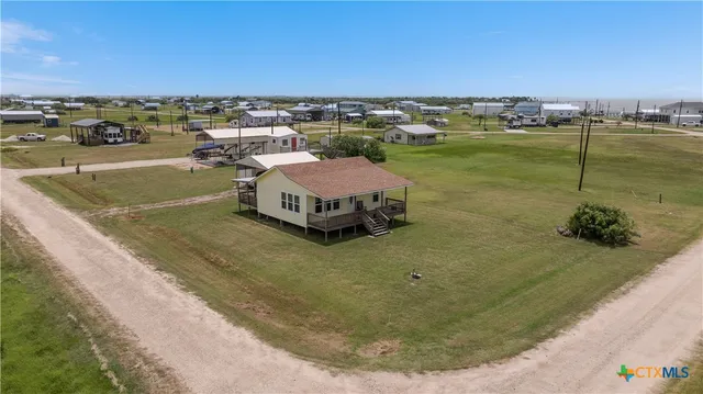 an aerial view of a house with a lake view