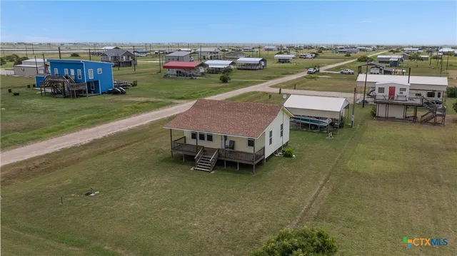 a view of a lake with lawn chairs