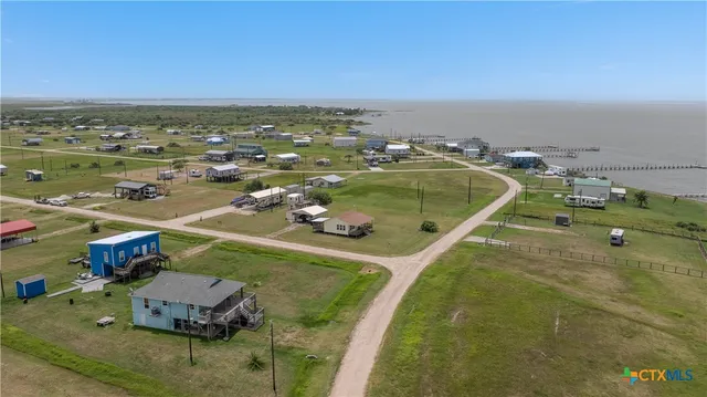 an aerial view of a house with a ocean view