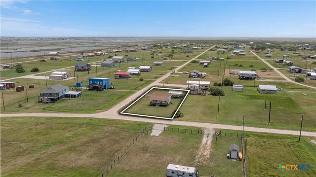 a front view of a house with swimming pool having outdoor seating
