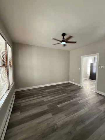 a kitchen with stainless steel appliances granite countertop a refrigerator oven a sink dishwasher and white cabinets with wooden floor