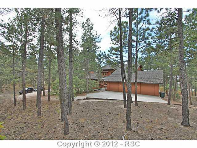 13010 Bridle Bit Road Colorado Springs, CO 80908 - Photo 2 of 25 5 acre lot ZONED FOR HORSES; Eco-shake roof ; UV shielding on many west facing windows, Hot tub off of lower deck with mountain views; Vaulted ceilings and skylights throughout.