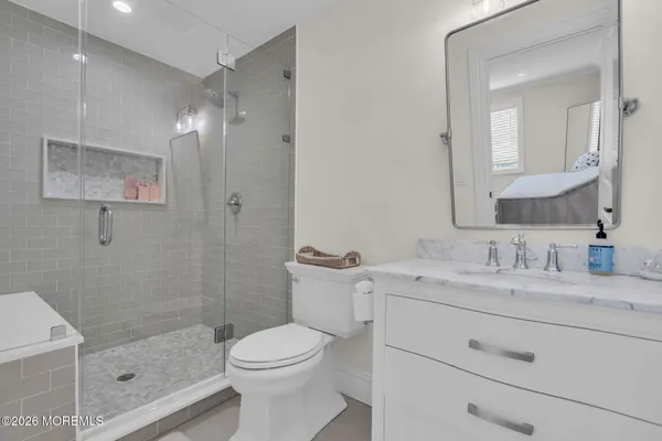 a bathroom with a toilet a sink and mirror