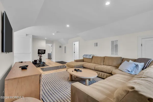 a bathroom with a sink a toilet a window and vanity