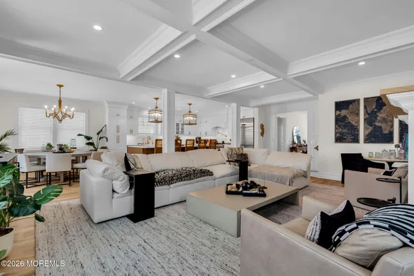 a view of a dining room with furniture and chandelier
