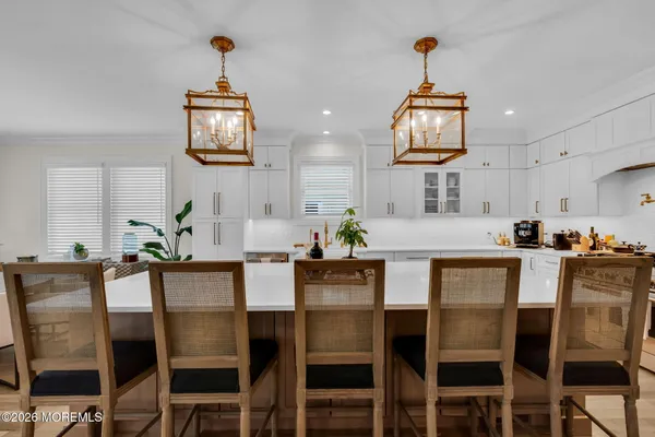 a kitchen with counter top space a sink appliances and cabinets