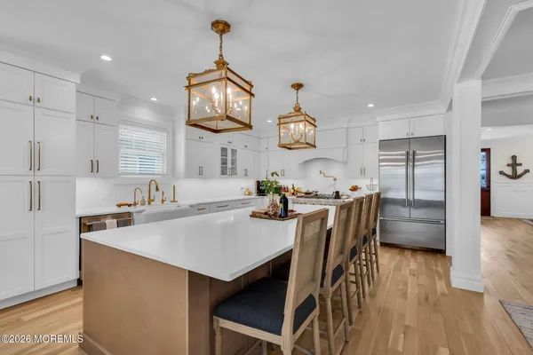a kitchen with stainless steel appliances granite countertop a stove and a wooden floors