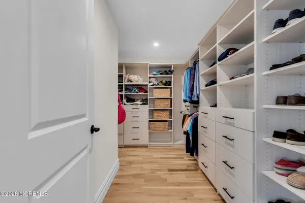 a view of a patio with couches chairs and wooden floor