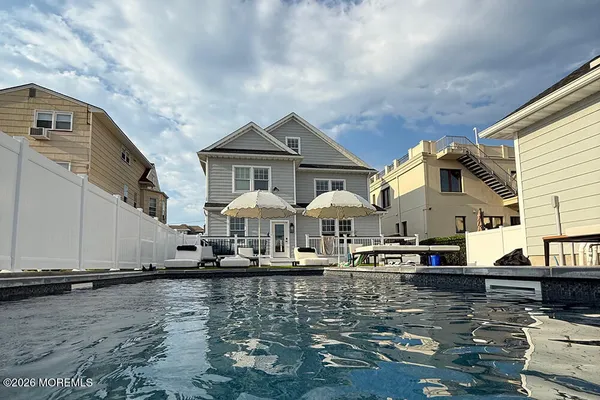 a view of a terrace with lawn chairs